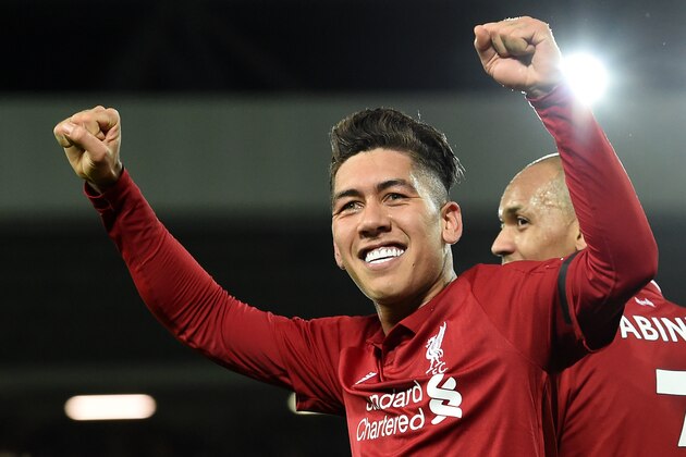 Liverpool's Brazilian midfielder Roberto Firmino (C) celebrates shooting from the penalty spot to score his team's fifth goal during the English Premier League football match between Liverpool and Arsenal at Anfield in Liverpool, north west England on December 29, 2018. (Photo by Paul ELLIS / AFP) / RESTRICTED TO EDITORIAL USE. No use with unauthorized audio, video, data, fixture lists, club/league logos or 'live' services. Online in-match use limited to 120 images. An additional 40 images may be used in extra time. No video emulation. Social media in-match use limited to 120 images. An additional 40 images may be used in extra time. No use in betting publications, games or single club/league/player publications. /         (Photo credit should read PAUL ELLIS/AFP/Getty Images)