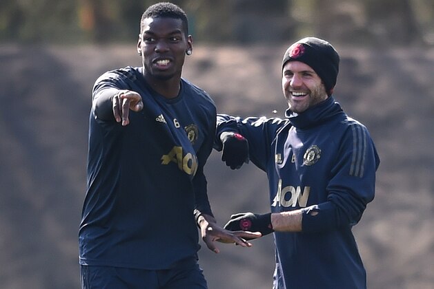 MANCHESTER, ENGLAND - APRIL 09: Paul Pogba of Manchester United speaks to Juan Mata of Manchester United during the Manchester United training session ahead of the UEFA Champions League Quarter Final First Leg match between Manchester United v FC Barcelona at Aon Training Complex on April 09, 2019 in Manchester, England. (Photo by Nathan Stirk/Getty Images)