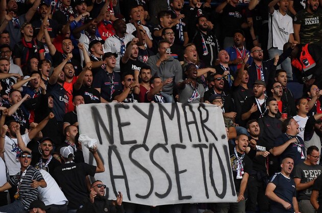 TOPSHOT - Paris Saint-Germain's supporters hold a banner reading
