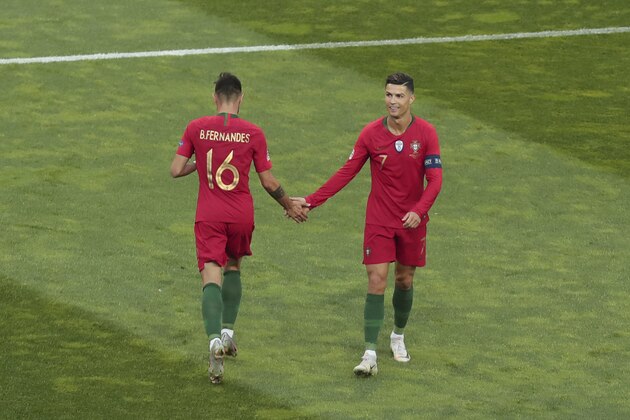 Portugal's Cristiano Ronaldo, right, shakes hands with Portugal's Bruno Fernandes during the UEFA Nations League final soccer match between Portugal and Netherlands at the Dragao stadium in Porto, Portugal, Sunday, June 9, 2019. (AP Photo/Luis Vieira)