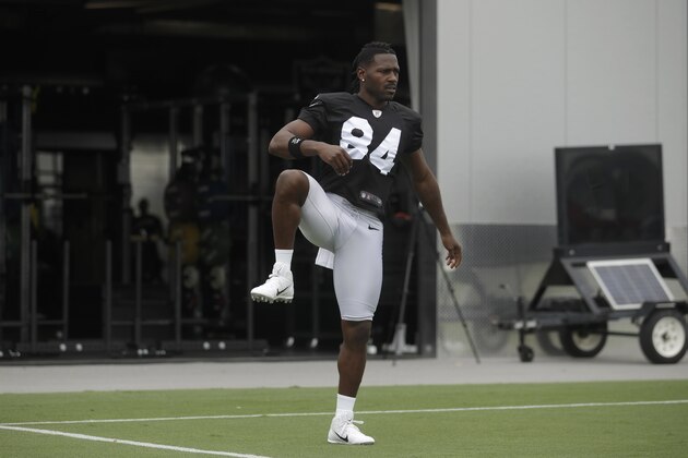 Oakland Raiders' Antonio Brown stretches during NFL football practice in Alameda, Calif., Tuesday, Aug. 20, 2019. (AP Photo/Jeff Chiu)