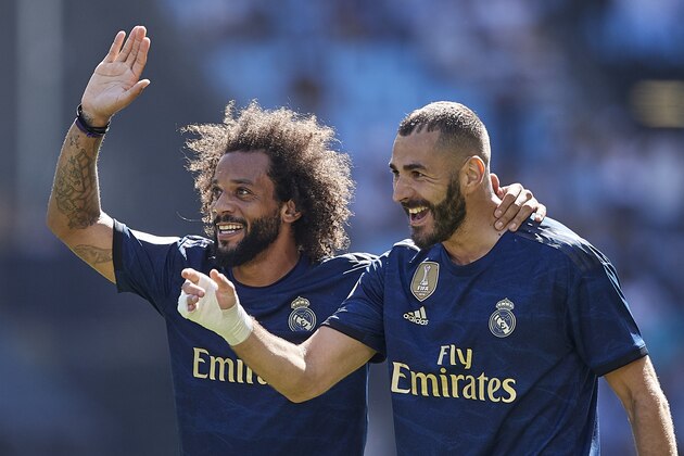 VIGO, SPAIN - AUGUST 17: Karim Benzema of Real Madrid celebrates with Marcelo after scoring his team's first goal during the Liga match between RC Celta de Vigo and Real Madrid CF at Abanca-Balaídos on August 17, 2019 in Vigo, Spain. (Photo by Quality Sport Images/Getty Images)