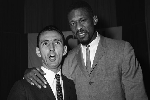 Bob Cousy, left and Bill Russell of the Boston Celtics sing a duet during a break-up party of the Celtics at a Boston Hotel, April 26, 1963. The Celtics won their fifth straight World Championship when they defeated the Los Angeles Lakers. This was Cousy's last season with Celtics after 13 seasons. He will coach Boston College next year. (AP PhotoBill Ingraham)