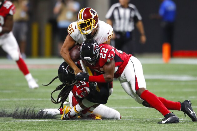 ATLANTA, GA - AUGUST 22: Tight end Jordan Reed #86 of the Washington Redskins is hit and loses his helmet by outside linebacker De'Vondre Campbell #59 of the Atlanta Falcons and strong safety Keanu Neal #22 in the first half of an NFL preseason game at Mercedes-Benz Stadium on August 22, 2019 in Atlanta, Georgia. (Photo by Todd Kirkland/Getty Images)