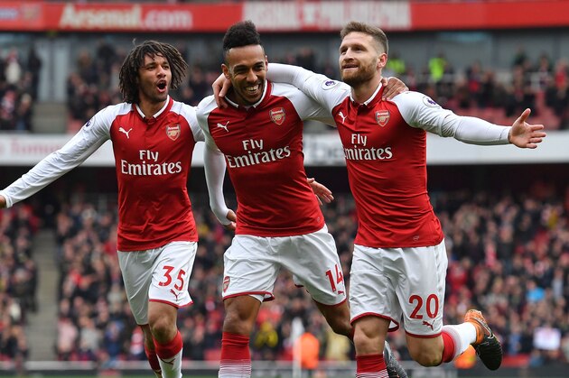 Arsenal's German defender Shkodran Mustafi (R) celebrates with Arsenal's Egyptian midfielder Mohamed Elneny (L) and Arsenal's Gabonese striker Pierre-Emerick Aubameyang (C) after scoring the opening goal of the English Premier League football match between Arsenal and Watford at the Emirates Stadium in London on March 11, 2018.  / AFP PHOTO / Ben STANSALL / RESTRICTED TO EDITORIAL USE. No use with unauthorized audio, video, data, fixture lists, club/league logos or 'live' services. Online in-match use limited to 75 images, no video emulation. No use in betting, games or single club/league/player publications.  /         (Photo credit should read BEN STANSALL/AFP/Getty Images)
