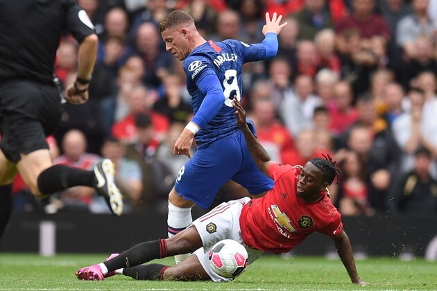 Manchester United's defender Aaron Wan-Bissaka (R) tackles Chelsea's English midfielder Ross Barkley during the English Premier League football match between Manchester United and Chelsea at Old Trafford in Manchester, north west England, on August 11, 2019. (Photo by Oli SCARFF / AFP) / RESTRICTED TO EDITORIAL USE. No use with unauthorized audio, video, data, fixture lists, club/league logos or 'live' services. Online in-match use limited to 120 images. An additional 40 images may be used in extra time. No video emulation. Social media in-match use limited to 120 images. An additional 40 images may be used in extra time. No use in betting publications, games or single club/league/player publications. /         (Photo credit should read OLI SCARFF/AFP/Getty Images)