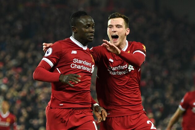 LIVERPOOL, ENGLAND - JANUARY 14:  Sadio Mane of Liverpool celebrates with team mate Andy Robertson after scoring the third Liverpool goal during the Premier League match between Liverpool and Manchester City at Anfield on January 14, 2018 in Liverpool, England.  (Photo by Shaun Botterill/Getty Images)
