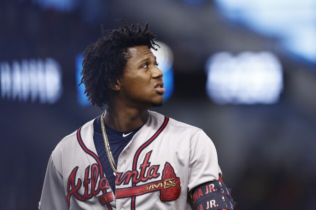Atlanta Braves' Ronald Acuna Jr. walks off the field after hitting a fly ball during the sixth inning of a baseball game against the Miami Marlins, Saturday, Aug. 10, 2019, in Miami. (AP Photo/Brynn Anderson)