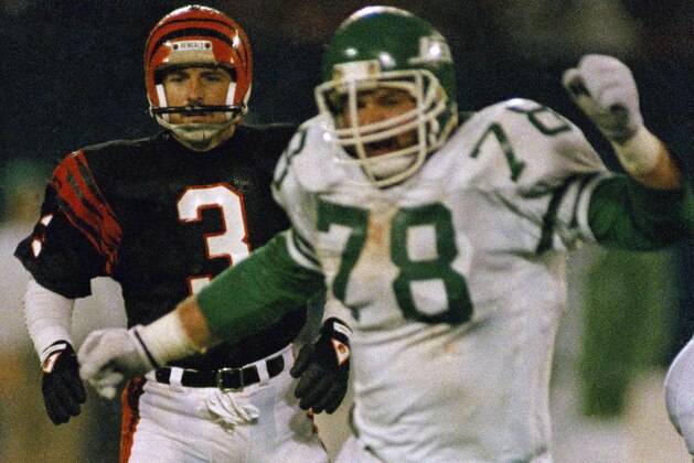 FILE - In this Nov. 30, 1987, file photo, Cincinnati Bengals place kicker Jim Breech (3) and New York Jets' Barry Bennett (78) react after Bennett blocked his game winning field goal attempt as they watch Jets' Rich Miano pick up the ball and run 67 yards for the winning touchdown in the fourth quarter of an NFL football game at Giants Stadium in East Rutherford, N.J. Authorities in Minnesota are investigating the deaths of a former NFL lineman and his wife and say the couple's son is a suspect. The bodies of 63-year-old Barry Bennett and his wife, Carol, were found Wednesday, Aug. 21, 2019, after a friend went to their home in Long Prairie for a welfare check. (AP Photo/Wilbur Funches, File)