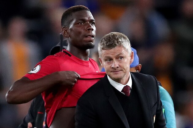 WOLVERHAMPTON, ENGLAND - AUGUST 19: Paul Pogba of Manchester United reacts alongside Ole Gunnar Solskjaer manager of Manchester United at full time during the Premier League match between Wolverhampton Wanderers and Manchester United at Molineux on August 19, 2019 in Wolverhampton, United Kingdom. (Photo by Marc Atkins/Getty Images)