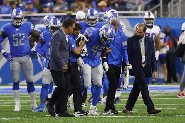 Detroit Lions middle linebacker Jarrad Davis (40) is helped off the field by medical staff during the first half of the team's NFL preseason football game against the Buffalo Bills in Detroit, Friday, Aug. 23, 2019. (AP Photo/Rick Osentoski)