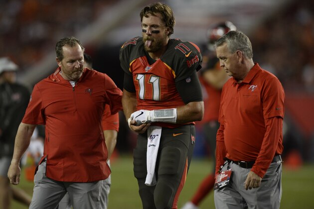 Tampa Bay Buccaneers quarterback Blaine Gabbert (11) gets helped off the field after getting injured on a run against the Cleveland Browns during the second half of an NFL preseason football game Friday, Aug. 23, 2019, in Tampa, Fla. (AP Photo/Jason Behnken)