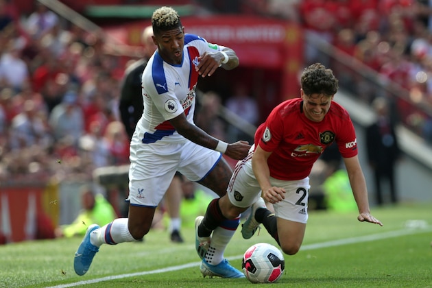 Manchester United's Welsh midfielder Daniel James (R) vies with Crystal Palace's Dutch defender Patrick van Aanholt (L) during the English Premier League football match between Manchester United and Crystal Palace at Old Trafford in Manchester, north west England, on August 24, 2019. (Photo by Lindsey Parnaby / AFP) / RESTRICTED TO EDITORIAL USE. No use with unauthorized audio, video, data, fixture lists, club/league logos or 'live' services. Online in-match use limited to 120 images. An additional 40 images may be used in extra time. No video emulation. Social media in-match use limited to 120 images. An additional 40 images may be used in extra time. No use in betting publications, games or single club/league/player publications. /         (Photo credit should read LINDSEY PARNABY/AFP/Getty Images)
