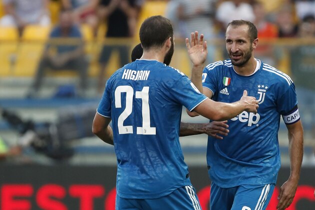 Juventus' Giorgio Chiellini, right, celebrates with teammates after scoring his side's opening goal during the Serie A soccer match between Parma and Juventus at the Tardini stadium, in Parma, Italy, Saturday, Aug. 24, 2019. (AP Photo/Antonio Calanni)