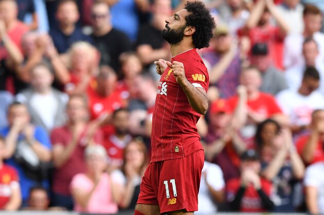 Liverpool's Egyptian midfielder Mohamed Salah celebrates after scoring their second goal from the penalty spot during the English Premier League football match between Liverpool and Arsenal at Anfield in Liverpool, north west England on August 24, 2019. (Photo by Ben STANSALL / AFP) / RESTRICTED TO EDITORIAL USE. No use with unauthorized audio, video, data, fixture lists, club/league logos or 'live' services. Online in-match use limited to 120 images. An additional 40 images may be used in extra time. No video emulation. Social media in-match use limited to 120 images. An additional 40 images may be used in extra time. No use in betting publications, games or single club/league/player publications. /         (Photo credit should read BEN STANSALL/AFP/Getty Images)