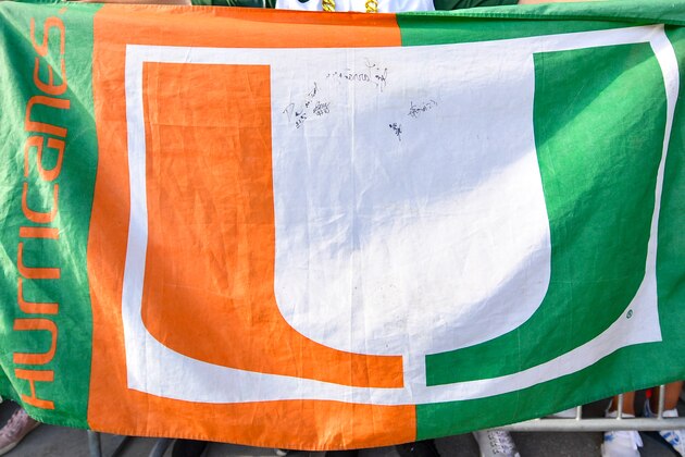 ORLANDO, FL - AUGUST 24: A fan of the Miami Hurricanes displays The U flag as the team arrives at the stadium before the game between the Florida Gators and the Miami Hurricanes for the Camping World Kickoff at Camping World Stadium on August 24, 2019 in Orlando, Florida. (Photo by Mark Brown/Getty Images)