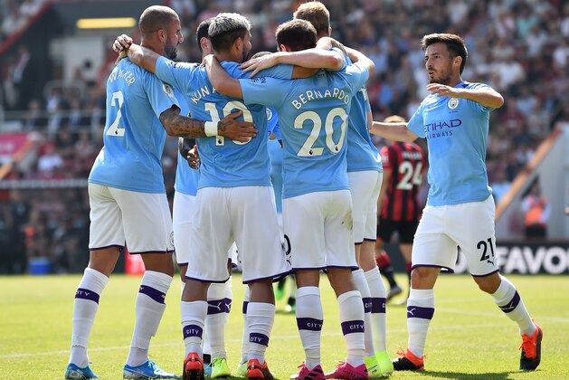 Manchester City's Argentinian striker Sergio Aguero (3L) celebrates scoring the opening goal during the English Premier League football match between Bournemouth and Manchester City at the Vitality Stadium in Bournemouth, southern England on August 25, 2019. (Photo by Glyn KIRK / AFP) / RESTRICTED TO EDITORIAL USE. No use with unauthorized audio, video, data, fixture lists, club/league logos or 'live' services. Online in-match use limited to 120 images. An additional 40 images may be used in extra time. No video emulation. Social media in-match use limited to 120 images. An additional 40 images may be used in extra time. No use in betting publications, games or single club/league/player publications. /         (Photo credit should read GLYN KIRK/AFP/Getty Images)