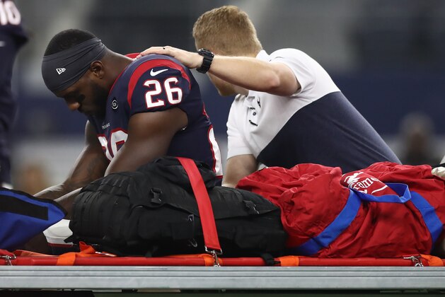 ARLINGTON, TEXAS - AUGUST 24:  Lamar Miller #26 of the Houston Texans leaves the game after an injury in the first quarter during a NFL preseason game against the Dallas Cowboys at AT&T Stadium on August 24, 2019 in Arlington, Texas. (Photo by Ronald Martinez/Getty Images)