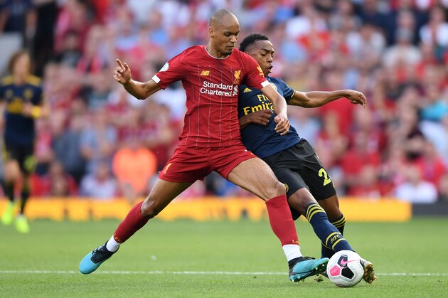 LIVERPOOL, ENGLAND - AUGUST 24: Fabinho of Liverpool tackles Joe Willock of Arsenal during the Premier League match between Liverpool FC and Arsenal FC at Anfield on August 24, 2019 in Liverpool, United Kingdom. (Photo by Laurence Griffiths/Getty Images)