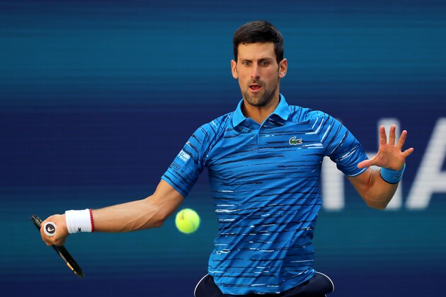 NEW YORK, NEW YORK - AUGUST 26:  Novak Djokovic of Serbia returns a shot during his Men's Singles first round match against Roberto Carballes Baena of Spain during day one of the 2019 US Open at the USTA Billie Jean King National Tennis Center on August 26, 2019 in the Flushing neighborhood of the Queens borough of New York City.  (Photo by Elsa/Getty Images)