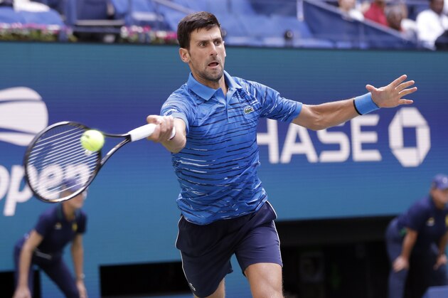 Novak Djokovic, of Serbia, returns a shot to Roberto Carballes Baena, of Spain, during the first round of the US Open tennis tournament Monday, Aug. 26, 2019, in New York. (AP Photo/Frank Franklin II)