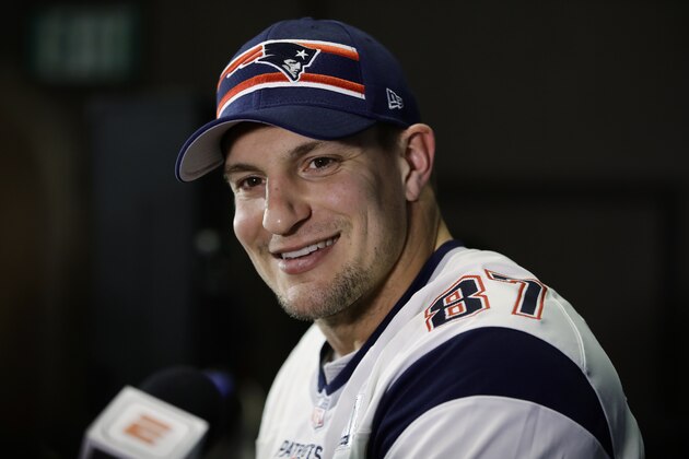 FILE - In this Jan. 30, 2019 file photo New England Patriots' Rob Gronkowski speaks with members of the media during a news conference ahead of the NFL Super Bowl 53 football game against Los Angeles Rams in Atlanta. As teams settle in at sweltering training camps this week, playbooks are distributed (digitally, of course), rookies and other youngsters try to catch the eye of decision makers, and fans wonder what their teams will look like in early September. And beyond. Except, perhaps, in New England. We’re not likely to see much of Patriots quarterback Tom Brady until opening day. We won’t see any of his buddy and standout tight end, Rob Gronkowski, whose battered body caused him to retire. (AP Photo/Matt Rourke, file)