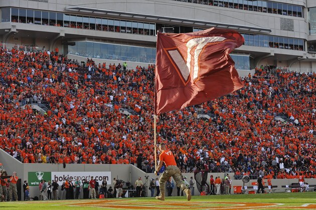 BLACKSBURG, VA - OCTOBER 21: A member of the Virginia Tech Corps of Cadets carries a flag through the end zone following a touchdown against the North Carolina Tar Heels in the first half at Lane Stadium on October 21, 2017 in Blacksburg, Virginia. Virginia Tech defeated North Carolina 59-7. (Photo by Michael Shroyer/Getty Images) *** Local Caption ***
