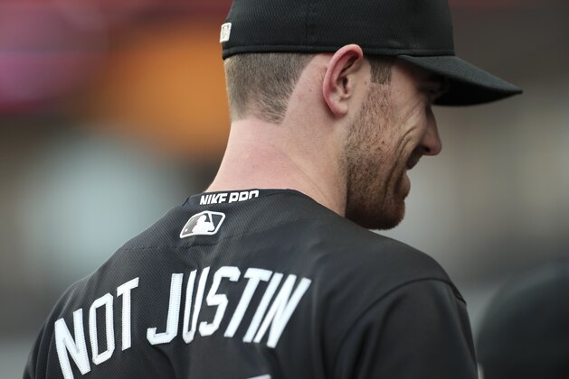CLEVELAND, OH - AUGUST 23: Shane Bieber #57 of the Cleveland Indians sits in the dugout during the first inning against the Kansas City Royals at Progressive Field on August 23, 2019 in Cleveland, Ohio. Teams are wearing special color schemed uniforms with players choosing nicknames to display for Players' Weekend. (Photo by Ron Schwane/Getty Images)
