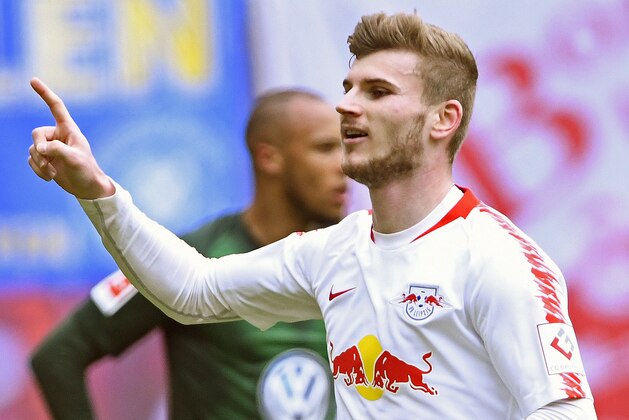 Leipzig's Timo Werner, right, celebrates after scoring his side's 2nd goal during the German Bundesliga soccer match between RB Leipzig and VfL Wolfsburg in Leipzig, Germany, Saturday, April 13, 2019. (AP Photo/Jens Meyer)