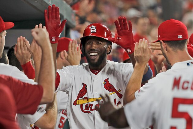 St. Louis Cardinals' Dexter Fowler is congratulated by teammates after hitting a two-run home run during the seventh inning of the team's baseball game against the Colorado Rockies on Thursday, Aug. 22, 2019, in St. Louis. (AP Photo/Jeff Roberson)