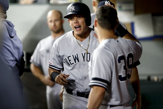 SEATTLE, WA - AUGUST 27:  Gio Urshela #29 of the New York Yankees is greeted by Mike Tauchman #39 after scoring on a groundout by Austin Romine in the fifth inning against the Seattle Mariners at T-Mobile Park on August 27, 2019 in Seattle, Washington. (Photo by Lindsey Wasson/Getty Images)