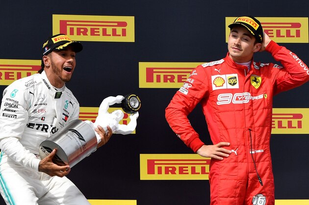 Winner Mercedes' British driver Lewis Hamilton (L) celebrates with his trophy next to third placed Ferrari's Monegasque driver Charles Leclerc on the podium after the Formula One Grand Prix de France at the Circuit Paul Ricard in Le Castellet, southern France, on June 23, 2019. (Photo by GERARD JULIEN / AFP)        (Photo credit should read GERARD JULIEN/AFP/Getty Images)