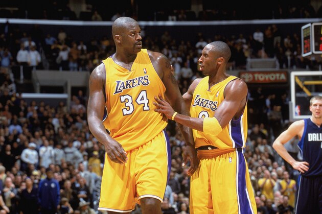 LOS ANGELES - DECEMBER 12:  Shaquille O'Neal #34 of the Los Angeles Lakers talks to his teammate Kobe Bryant #8 during the game against the Dallas Mavericks at Staples Center on December 12, 2003 in Los Angeles, California.  The Lakers won 106-83.  NOTE TO USER: User expressly acknowledges and agrees that, by downloading and/or using this Photograph, User is consenting to the terms and conditions of the Getty Images License Agreement Mandatory  (Photo by Andrew D. Bernstein/NBAE via Getty Images)