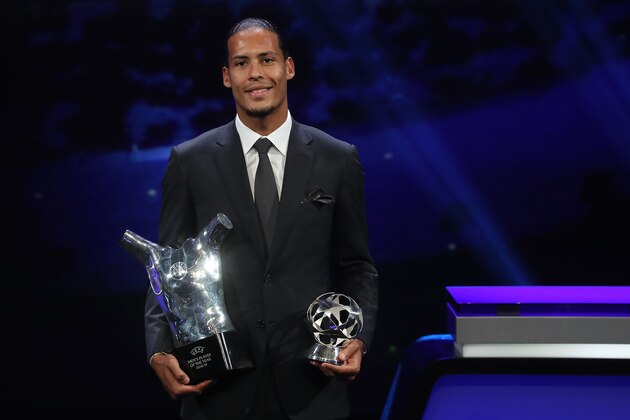 Liverpool's Dutch defender Virgil van Dijk poses with his trophies of Best Men's player in Europe of the Year and Best Defender at the end of the UEFA Champions League football group stage draw ceremony in Monaco on August 29, 2019. (Photo by Valery HACHE / AFP)        (Photo credit should read VALERY HACHE/AFP/Getty Images)