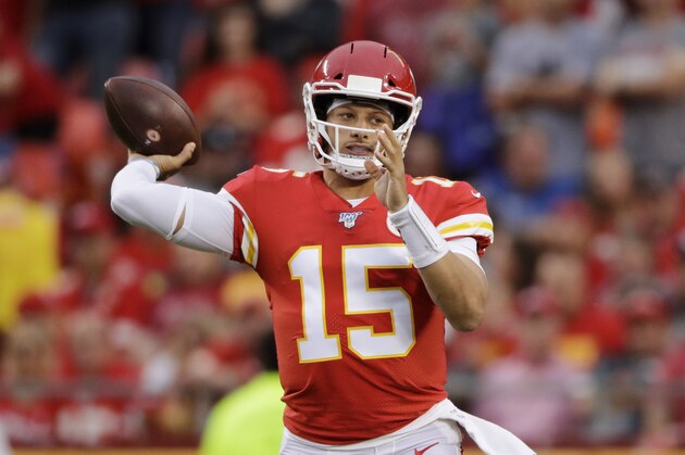 Kansas City Chiefs quarterback Patrick Mahomes (15) throws a touchdown pass to running back Damien Williams during the first half of an NFL preseason football game against the San Francisco 49ers in Kansas City, Mo., Saturday, Aug. 24, 2019. (AP Photo/Charlie Riedel)