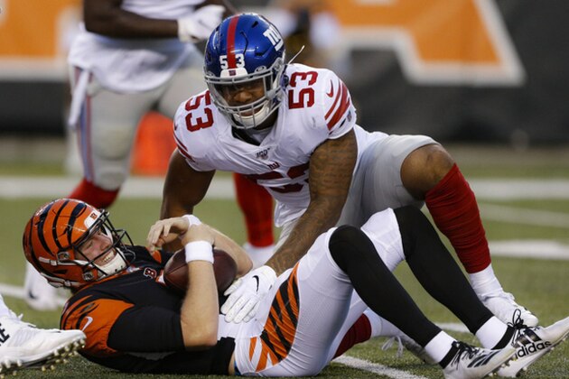 Cincinnati Bengals quarterback Ryan Finley lies on the ground after being sacked by New York Giants linebacker Oshane Ximines (53) during the first half of an NFL preseason football game Thursday, Aug. 22, 2019, in Cincinnati. (AP Photo/Gary Landers)