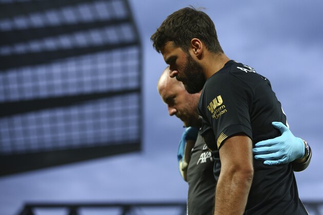 Liverpool's goalkeeper Alisson Becker leaves the pitch after an injury during the English Premier League soccer match between Liverpool and Norwich City at Anfield in Liverpool, England, Friday, Aug. 9, 2019. (AP Photo/Dave Thompson)