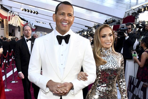 FILE - In this Sunday, Feb. 24, 2019, file photo, Alex Rodriguez, left, and Jennifer Lopez arrive at the Oscars at the Dolby Theatre in Los Angeles. Rodriguez and Lopez are engaged. The couple posted an Instagram photo of their hands with a massive engagement ring on Lopez’s ring finger. (Photo by Charles Sykes/Invision/AP, File)