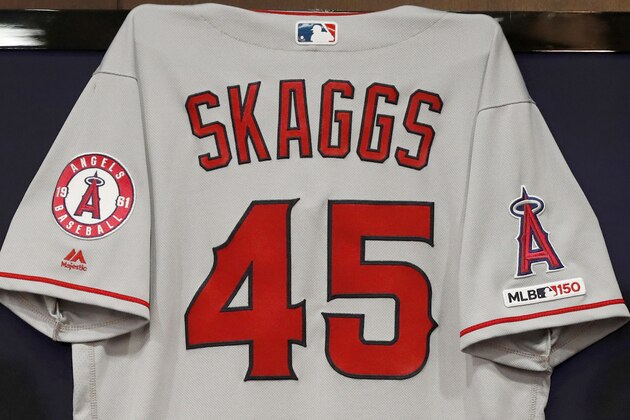 The jersey of the late Tyler Skaggs hangs on the wall during a news conference with team management and ownership before a baseball game against the Texas Rangers in Arlington, Texas, Tuesday, July 2, 2019. Skaggs passed away on Monday in Southlake, Texas. (AP Photo/Tony Gutierrez)