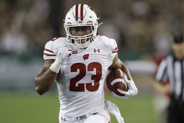 Wisconsin running back Jonathan Taylor (23) scores on a 37-yard tun against South Florida during the first half of an NCAA college football game Friday, Aug. 30, 2019, in Tampa, Fla. (AP Photo/Chris O'Meara)