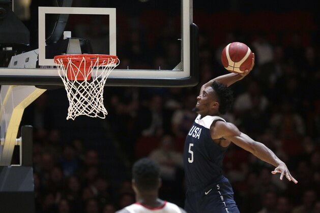 United States' Donovan Mitchell jumps up to dunk the ball against Canada  during their exhibition basketball game in Sydney, Australia, Monday, Aug. 26, 2019. (AP Photo/Rick Rycroft)