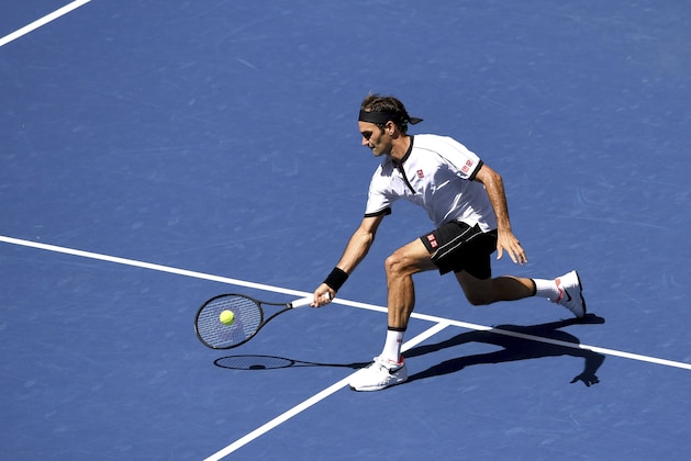 Roger Federer, of Switzerland, returns a shot to Daniel Evans, of the United Kingdom, during round three of the US Open tennis championships Friday, Aug. 30, 2019, in New York. (AP Photo/Sarah Stier)