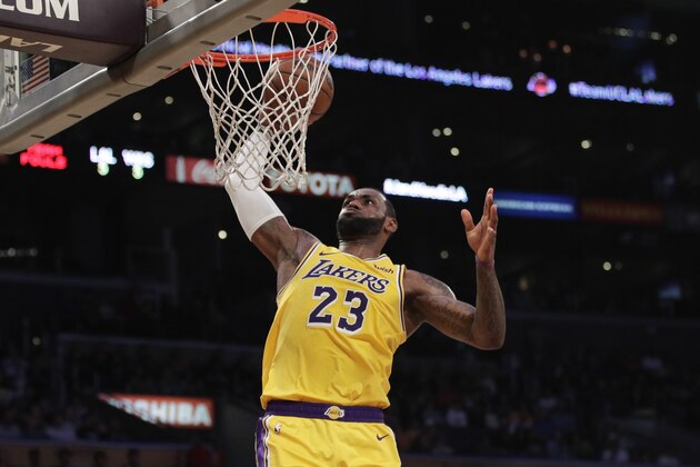 Los Angeles Lakers' LeBron James goes up for a dunk during the first half of an NBA basketball game against the Washington Wizards, Tuesday, March 26, 2019, in Los Angeles. (AP Photo/Jae C. Hong)