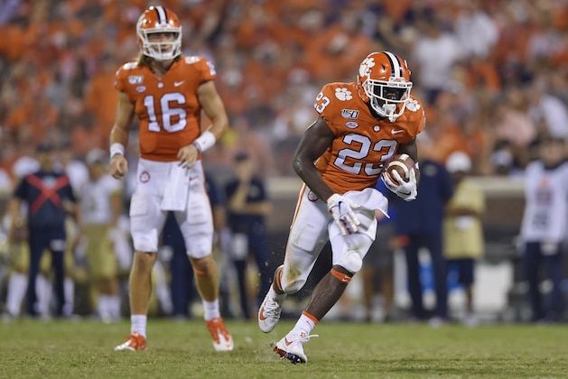 Clemson's Lyn-J Dixon (23) rushes for a touchdown after taking a handoff from quarterback Trevor Lawrence (16) during the second half of an NCAA college football game against Georgia Tech Thursday, Aug. 29, 2019, in Clemson, S.C. Clemson won 52-14. (AP Photo/Richard Shiro)
