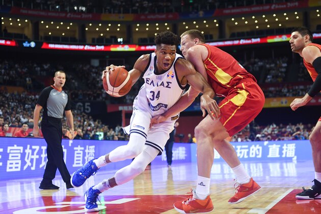 Greece's Giannis Antetokounmpo (L) is challenged by a defender during the Basketball World Cup Group F game between Greece and Montenegro in Nanjing on September 1, 2019. (Photo by WANG Zhao / AFP)        (Photo credit should read WANG ZHAO/AFP/Getty Images)
