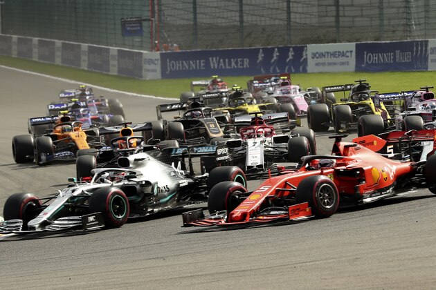 Mercedes driver Lewis Hamilton of Britain, left, and Ferrari driver Sebastian Vettel of Germany, right, steer their cars into the first corner during the Belgian Formula One Grand Prix in Spa-Francorchamps, Belgium, Sunday, Sept. 1, 2019. (AP Photo/Francisco Seco)