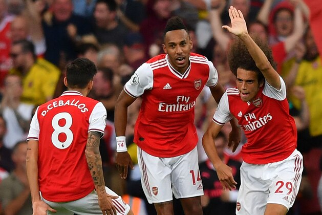 Arsenal's Gabonese striker Pierre-Emerick Aubameyang (C) and Arsenal's French midfielder Matteo Guendouzi (R) celebrate after Aubameyang latched onto Guendouzi's pass to score their second goal to equalise 2-2 during the English Premier League football match between Arsenal and Tottenham Hotspur at the Emirates Stadium in London on September 1, 2019. (Photo by Ben STANSALL / AFP) / RESTRICTED TO EDITORIAL USE. No use with unauthorized audio, video, data, fixture lists, club/league logos or 'live' services. Online in-match use limited to 120 images. An additional 40 images may be used in extra time. No video emulation. Social media in-match use limited to 120 images. An additional 40 images may be used in extra time. No use in betting publications, games or single club/league/player publications. /         (Photo credit should read BEN STANSALL/AFP/Getty Images)