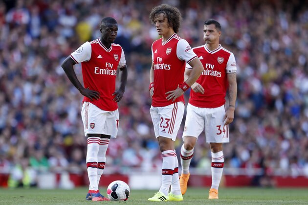 Arsenal's Nicolas Pepe, left, Arsenal's David Luiz, enter and Arsenal's Granit Xhaka prepare for a free kick during their English Premier League soccer match between Arsenal and Tottenham Hotspur at the Emirates stadium in London, Sunday, Sept. 1, 2019. (AP Photo/Alastair Grant)