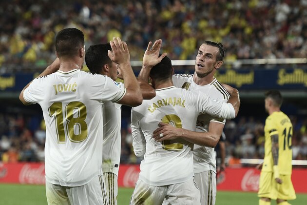 Real Madrid's Welsh forward Gareth Bale (R) celebrates with teammates after scoring during the Spanish league football match Villarreal CF against Real Madrid CF at La Ceramica stadium in Vila-real on September 1, 2019. (Photo by Josep LAGO / AFP)        (Photo credit should read JOSEP LAGO/AFP/Getty Images)