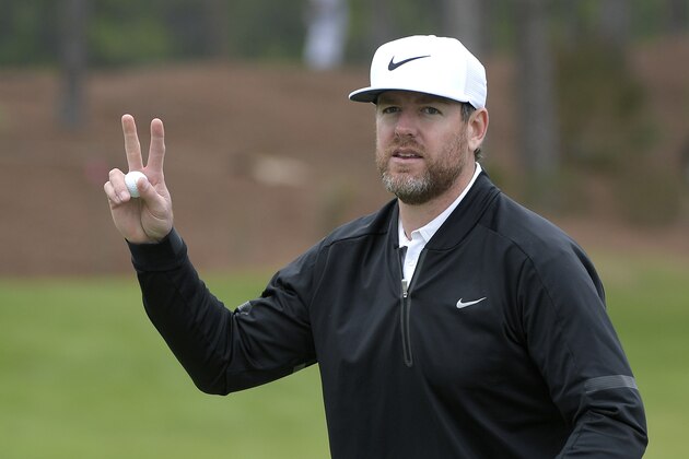 Former NFL quarterback Carson Palmer acknowledges the crowd after making a putt on the 18th green during the final round of the Tournament of Champions LPGA golf tournament Sunday, Jan. 20, 2019, in Lake Buena Vista, Fla. (AP Photo/Phelan M. Ebenhack)